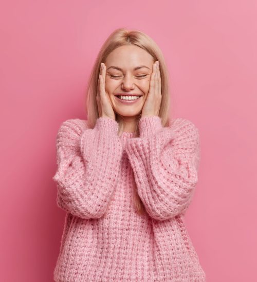 positive-sincere-blonde-woman-keeps-hands-on-cheek-2021-08-31-08-44-38-utc.jpg